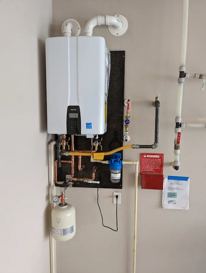 Professional plumber installing copper piping in a Spanish Fort home